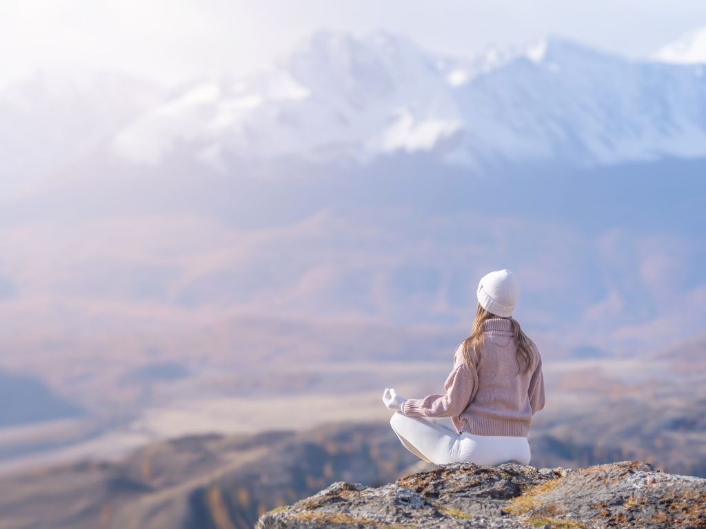 una-donna-in-meditazione-in-montagna